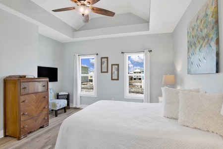 Bedroom 2 has a TV, ceiling fan and a private bath