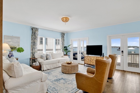 The living room has balcony access and TV