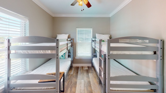 Bedroom 4 is on the 2nd floor and sleeps 4 guests in 2 twin bun beds, has a TV and a ceiling fan