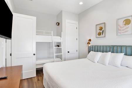 Bedroom #6 on the 3rd floor sleeps 4 in a king + 2 twin bunks. The room also has a private bathroom and a TV