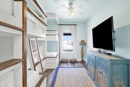 This second bunk room comfortably sleeps 6, has a TV and a bathroom