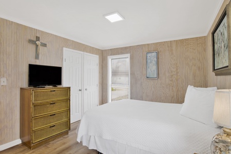The master bedroom sleeps 2 guests and has a TV
