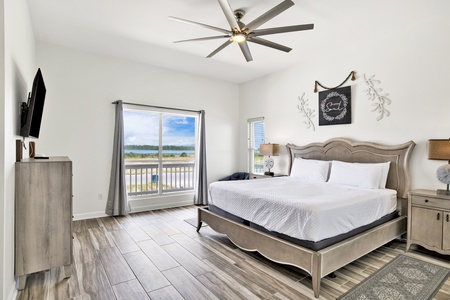 Bedroom #2 has a king bed, ceiling fan and lagoon views