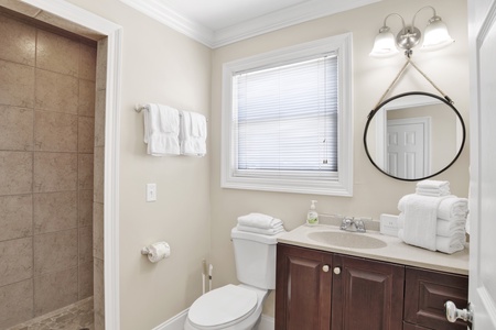 The private bathroom features a walk-in tile shower