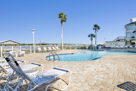 Community pool with loungers and a Lagoon view