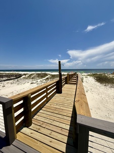 Private boardwalk to the beach with a shower