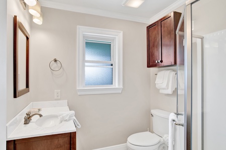 The hall bathroom features a walk in shower