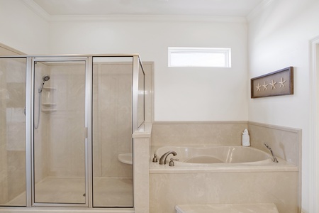 Bama Boat House South master bathroom with a walk-in shower and soaking tub