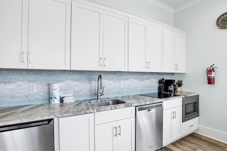 The 2nd kitchen offers stone counters and stainless appliances