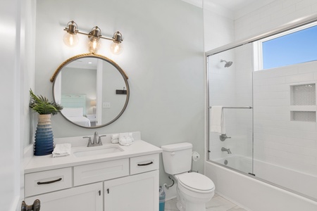 The guest bathroom features a tub/shower combo