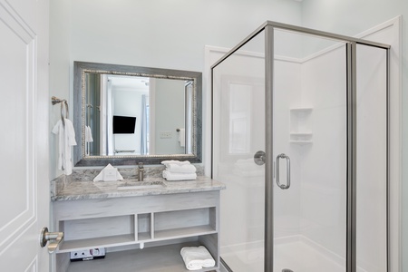 The private bathroom features a walk-in shower