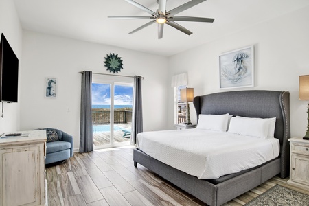 Bedroom #3 features a king bed, Gulf views, ceiling fan and access to the deck