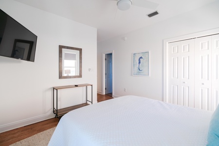 Bedroom 2 comes with a ceiling fan and a television