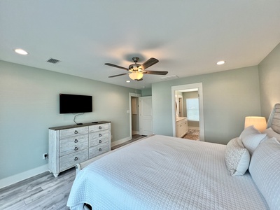 The master bedroom has a TV and King bed, sleeps 2