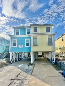 Covered parking for up to three vehicles with additional parking in the driveway.