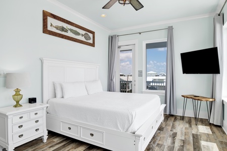 Bedroom 1 offers a King bed, TV, balcony access and private bathroom