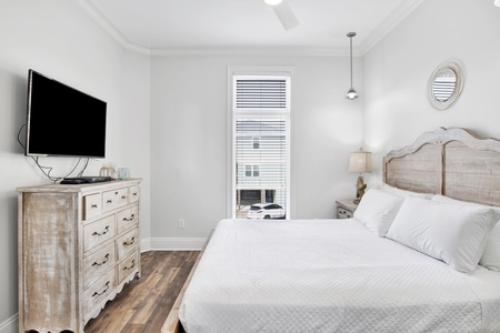 Bedroom 5 has a TV, ceiling fan and entrance into the attached bathroom