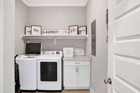 The walk-in laundry room offers a full size washer and dryer