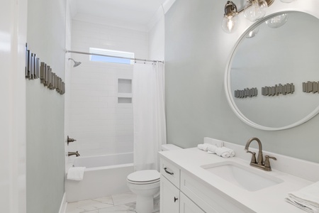 Shared hall bathroom features a tub/shower combo