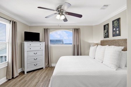This guest bedroom offers a King bed, TV and private bathroom