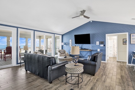 The living room offers screened porch access and a sofa sleeper that can accommodate 2