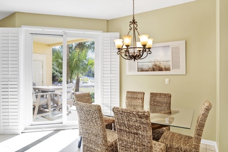 Bright dining area with seating for 6 and access to the patio