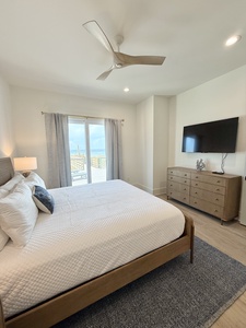 The master bedroom offers a TV and King bed, sleeps 2