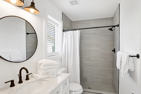 The private bathroom has a walk-in tile shower