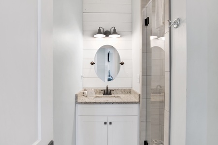 Shared hallway bathroom features a walk-in shower