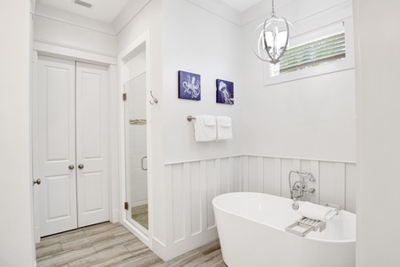 Featuring a walk-in tile shower and soaking tub