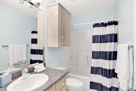 Bathroom with a tub/shower combo attached to bedroom 2- also a hall entrance
