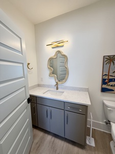 The private bathroom has a single vanity