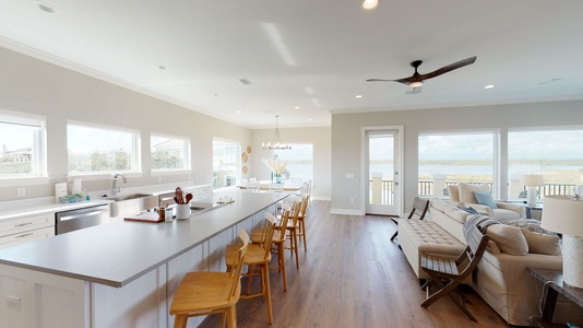 Open floor plan with 5 chairs at the kitchen bar on top floor