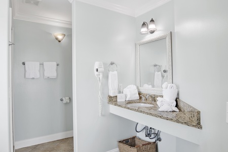 The private bathroom offers a single vanity