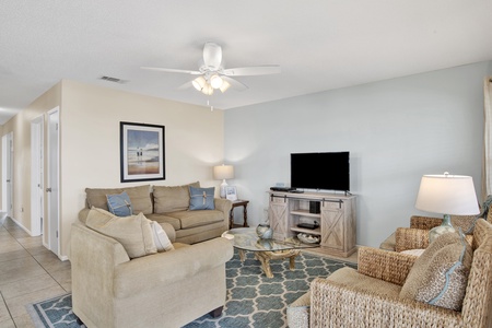 Comfortable sectional, ceiling fan and television