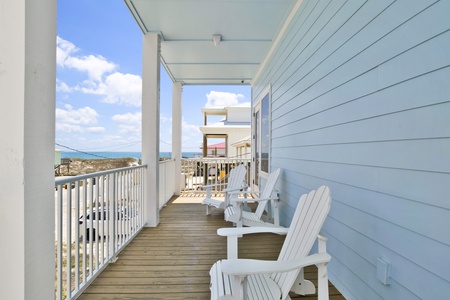 The covered balcony offers views of the Gulf