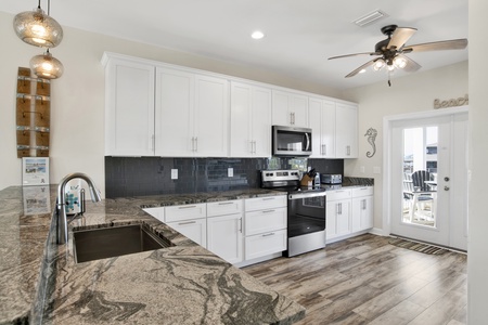 Beautiful stone counters, tile backsplash and flooring throughout