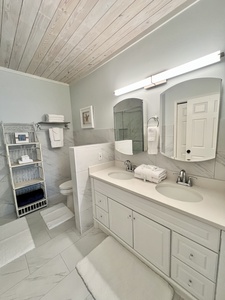The private bathroom features dual vanities