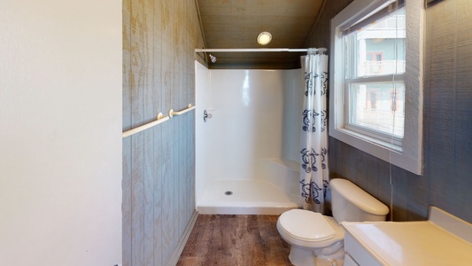Upstairs loft full bathroom with a walk in shower