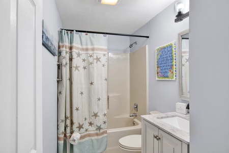 Shared hall bathroom with a tub/shower combo