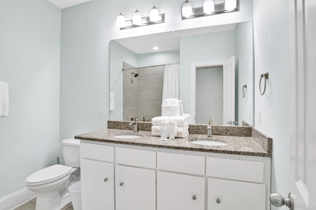 Shared hall bathroom on the 2nd floor with a double vanity and a tub/shower combo