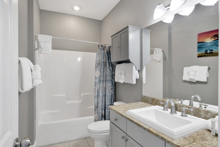 Full bathroom with shower/tub combo located off of the kitchen and bedroom 2