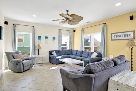 Bright, spacious living area with multiple seating options to accommodate large families