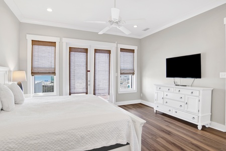 It features a TV, balcony access and private bathroom