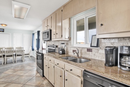 Updated kitchen with granite countertops and tile backsplash