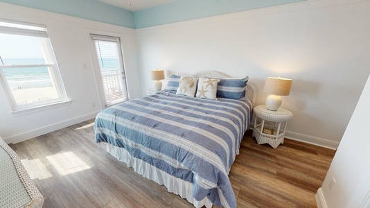 Bedroom 4 located upstairs features a king bed, TV with cable, access to the balcony with beach views and an attached, private bathroom