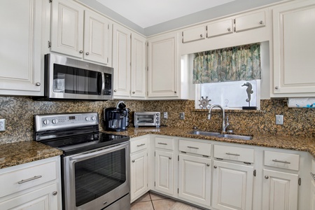 Stainless appliances and granite backsplash and countertops