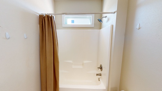 The bathroom in bedroom 2 has a tub/shower combo