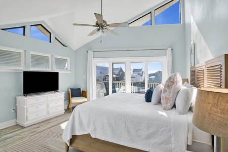 Hello Waves (unit B) Master bedroom with a king bed, TV, balcony access and a private bathroom