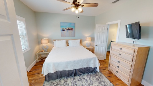 The Master bedroom sleeps 2 in a king bed and has a ceiling fan